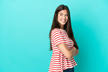 Fototapeta premium Young Brazilian woman isolated on blue background looking to the side and smiling