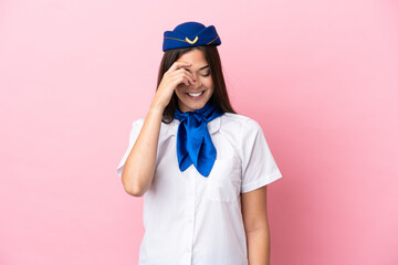 Airplane stewardess Brazilian woman isolated on pink background laughing