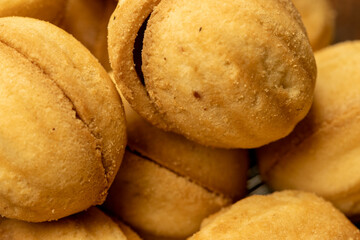 Homemade cookies in the shape of a nut with a sweet filling. Close-up, selective focus.