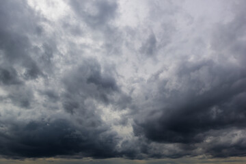 The dark sky with heavy clouds converging and a violent storm before the rain.Bad or moody weather...