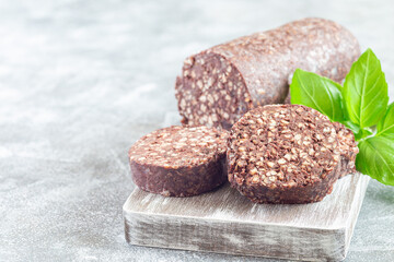 Irish and British black pudding sausage slices on a wooden board, horizontal, copy space