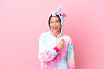 Young caucasian woman with unicorn pajamas isolated on pink background celebrating a victory
