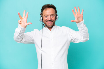 Telemarketer caucasian man working with a headset isolated on blue background counting nine with fingers