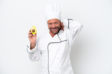 Chef man holding an avocado isolated on white background laughing