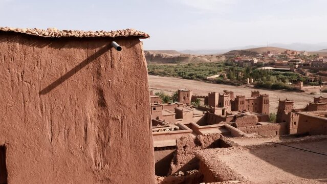 High angle view of the Ksar Kasbah Ait Benhaddou. A rural village with old clay houses, authentic traditional South Moroccan country-style adobe architecture. 4k footage. 