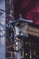 Vintage iron street lamp on a brick wall