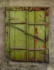 Old window with closed shutters.