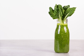 Bottle of green smoothie with kale. Smoothies with chlorophyll copy space
