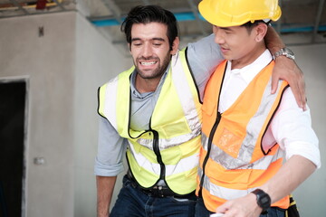 injured lying worker at work being assisted. Engineer injured in an accident at work on the industry factory work ,call form help. Construction worker accident with a construction worker.