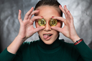 Beautiful woman holding a bitcoin