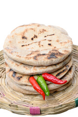 closeup the bunch brown color tortilla with red green chilly in the grey brown bucket on the white background.