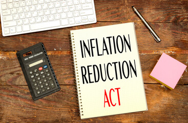 notebook with Inflation Reduction Act concept near calculator and keyboard