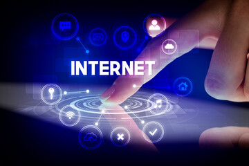 Finger touching tablet with web technology icons concept