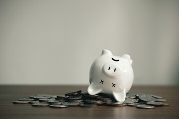 The dead piggy bank lies upside down on coins. Economic depression. The financial crisis, end of...