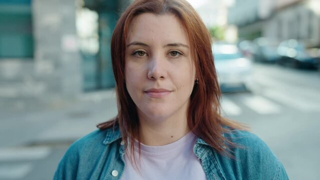 Young beautiful plus size woman smiling confident standing at street