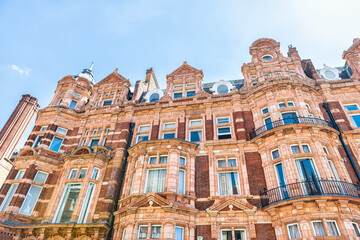 Fototapeta na wymiar Apartment flats house building in Gothic revival style architecture in Mayfair, Westminster of London UK by Park lane street road near Hyde park