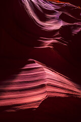 Shadows light at upper Arizona Antelope slot canyon with wave shape abstract sandstone rock formations pattern of red orange layers lines
