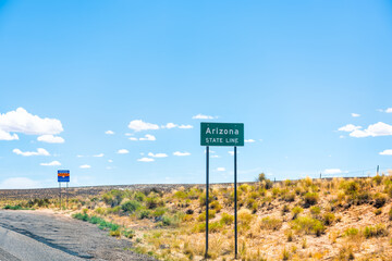 Obraz premium Page, USA with state line border with welcome to Arizona sign entering from Kanab, Utah with summer desert barren dry landscape