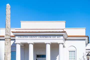 Fototapeta premium Walterboro, USA Colleton county courthouse clerk of court building sign at white architecture facade in South Carolina city