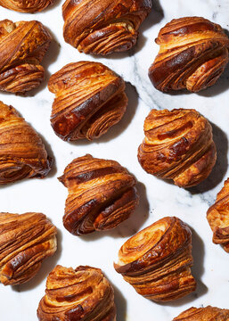 Multiple croissants in graphic pattern on marble