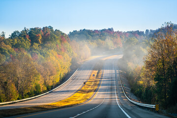 Fog mist covering forest trees at sunrise in West Virginia rural countryside by New River Gorge in...