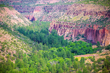 Naklejka premium View of canyon overlook vista in Bandelier National Monument in New Mexico in Los Alamos at summer with Jemez mountains rock formations