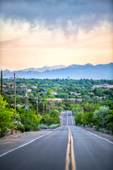 Santa Fe, New Mexico colorful sunset on Bishops Lodge Road with golden light and green plants by...