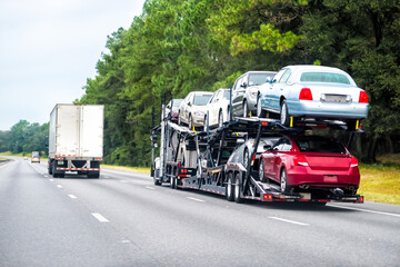 Fototapeta na wymiar Truck trailer hauler transportation, commercial transport hauling brand new cars for auto dealership on Florida highway road