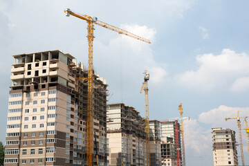 Construction site with crane and building. Construction of a residential multi-storey building.