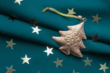 golden Christmas tree and sparkles in the form of stars - Christmas decoration for home and Christmas tree, elegant background and banner