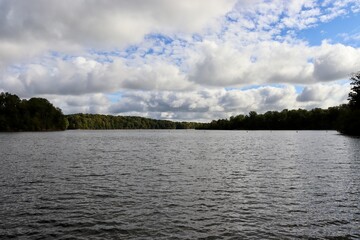 A beautiful view of the lake and the clouds in the sky.