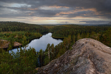 Fototapeta na wymiar Northern landscape, blue lakes among the Spruce forest. The nature of the Karelian Isthmus and the rocks of the Triangular Lake, view from the top 