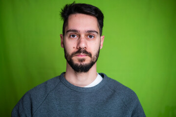 Obraz premium Young man with casual clothes, posing on green background