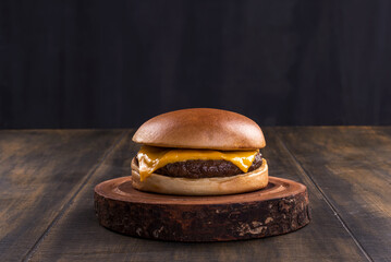 delicious fast food cheeseburger on a rustic wooden table