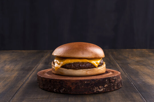 delicious fast food cheeseburger on a rustic wooden table