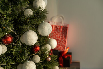 Beautiful Christmas gifts under fir tree on floor in room
