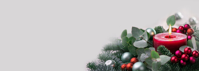 Christmas Background  - Burning Red Advent Candle on grey background -   Panorama, Banner with copy space