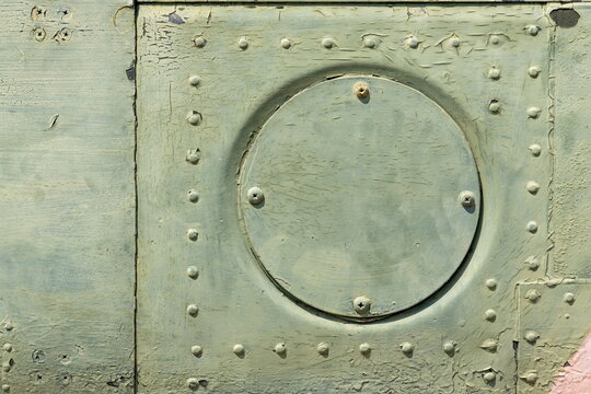 The exterior wall surface of the military helicopter is very old military green paint peeling off. in the bright sunlight during the day