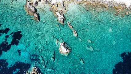 Aerial view of small rock formation in clear sea water at Agia Eleni Beach, Kefalonia Island, Greece