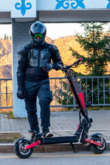 a man in full protection with a sports electric scooter