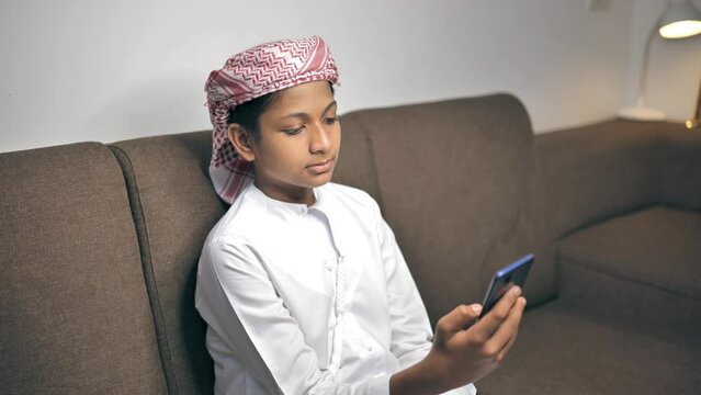 Muslim Indian Boy Holding a Phone	