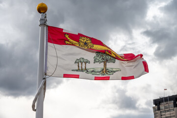 Flag of Prince Edward Island waiving on a cloudy Canadian day.