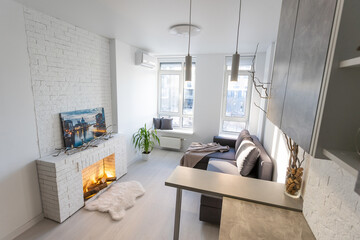 Fototapeta na wymiar Modern minimalistic dark gray loft style studio apartment interior design. kitchen, sitting area, workplace