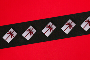 red black background, on the black part white gift packages, creative holiday concept
