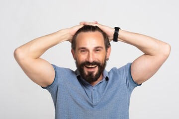 Fototapeta na wymiar handsome excited surprised beard man happy smile looking at camera, hold hands on head, senior guy wear blue polo shirt, white teeth, isolated over white background. Unexpected good news.