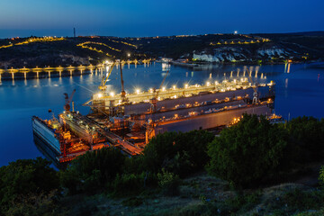 Ship repair dry docks at night, aerial view