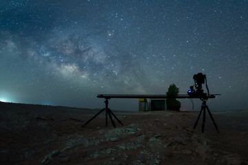 Camera with slider taking time lapse Milky way stars in the desert empty quarter.