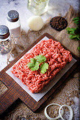 Raw fresh minced meat with cilantro leaves, onion slices and pepper