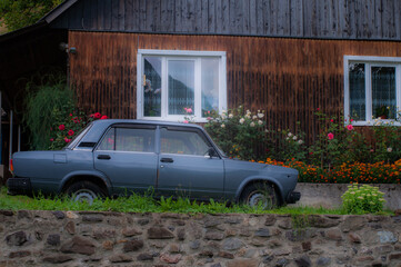old car in front of a house