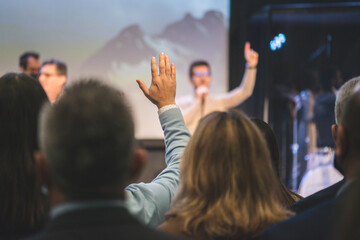 Hands in the air of people who praise God at church service - 542053325